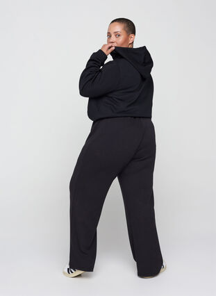 Wide sweatpants with drawstrings in the waist, Black, Model image number 1