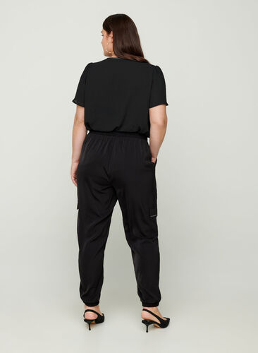 Loose trousers with large pockets, Black, Model image number 0
