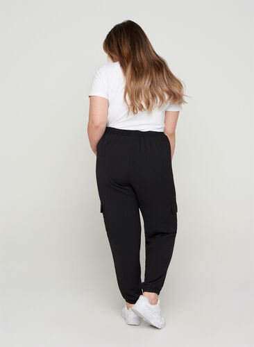 Loose trousers with large pockets, Black, Model image number 1