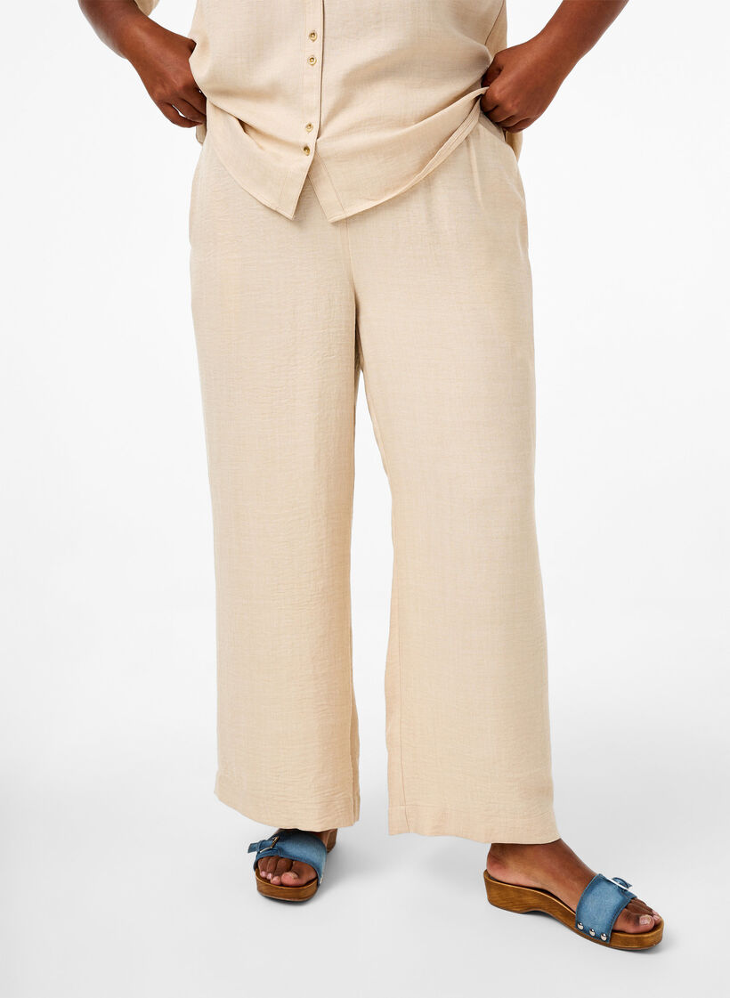 Loose trousers with elasticated waistband and pockets, Beige, Model image number 2