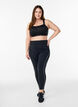 Sports bra with a front closure and high support, Black, Model image number 1