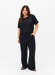 Loose trousers with hole pattern, Black, Model image number 0