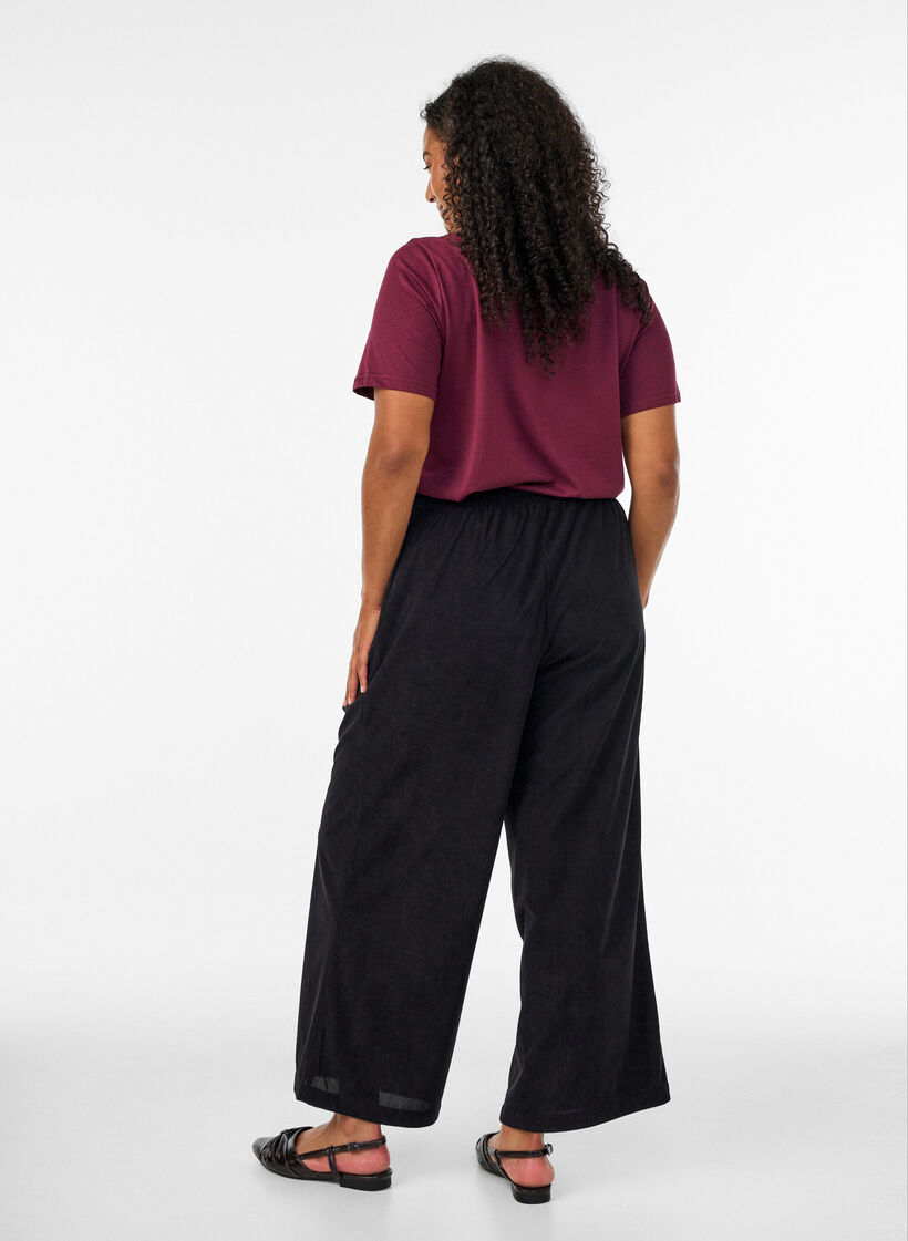 Corduroy trousers with wide legs and a high waist, Black, Model image number 1
