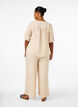 Loose trousers with elasticated waistband and pockets, Beige, Model image number 1